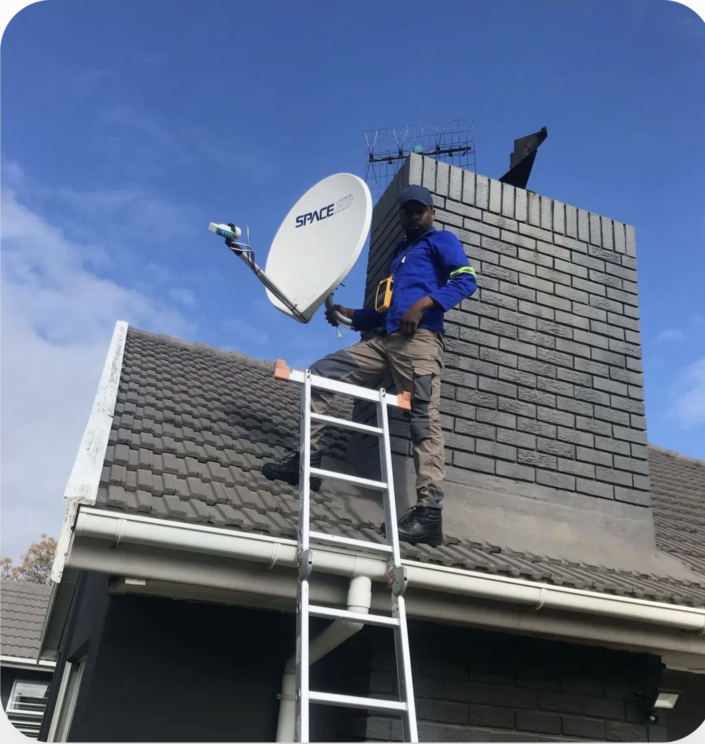 Accredited DStv installer aligning a satellite dish on a rooftop